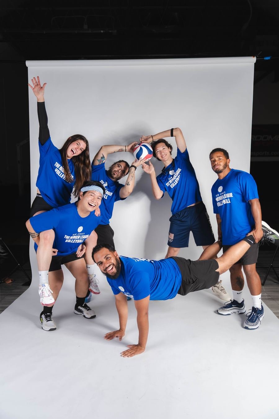 Volleyball squad in blue clowning for the camera